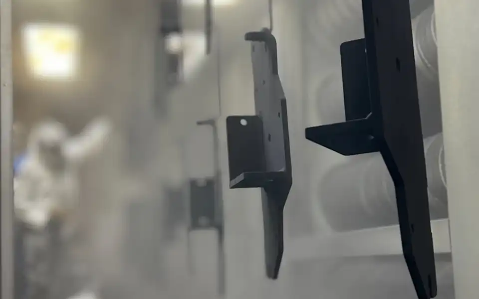 powdercoat part in booth